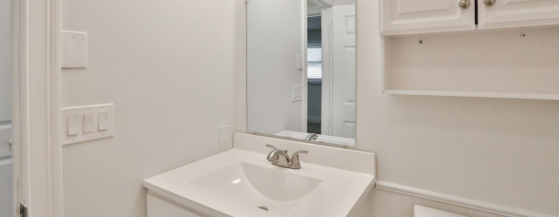 Spacious bathrooms with everything you need a bathroom with a mirror and sink