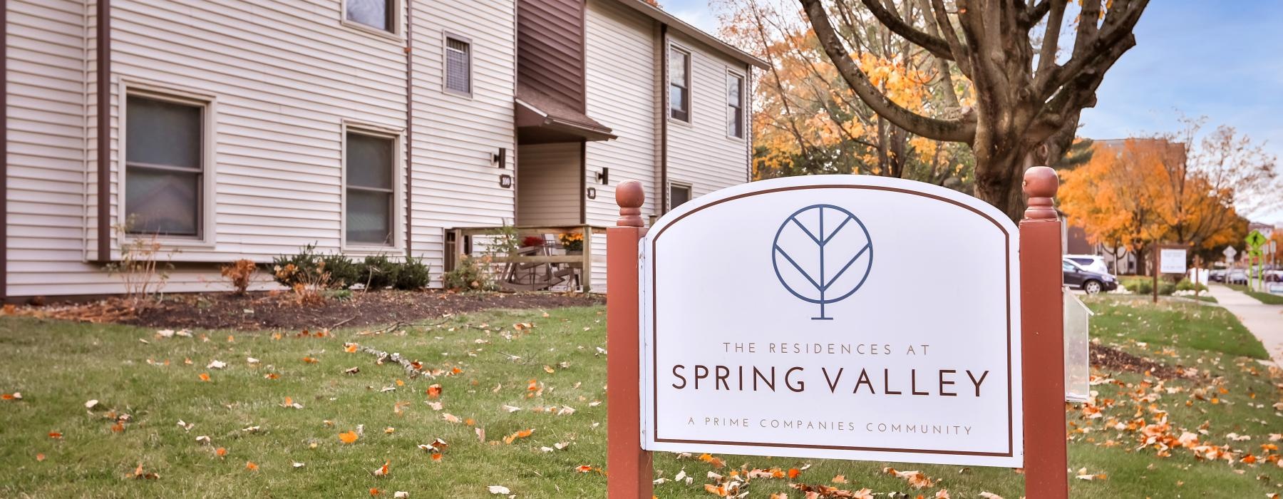 a sign in front of an apartment building